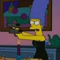 Marge pointing two pistols at Homer