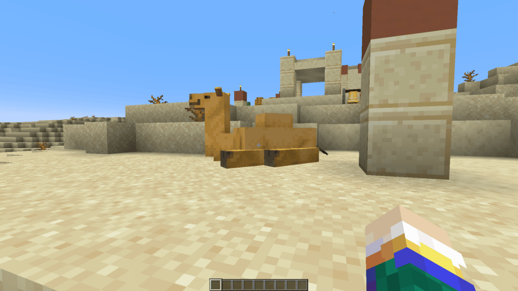 Un camello en Minecraft 1.20 sentado en un pueblo del desierto.