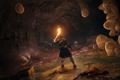 Character holding a torch in a dark cave