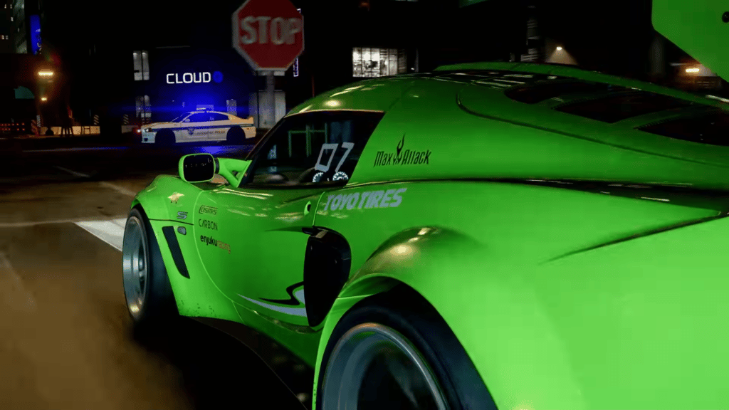 Close door-level shot of a green racing car being menacingly approached by a cop car.