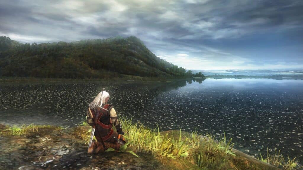 Image shows the main character sitting by an ocean