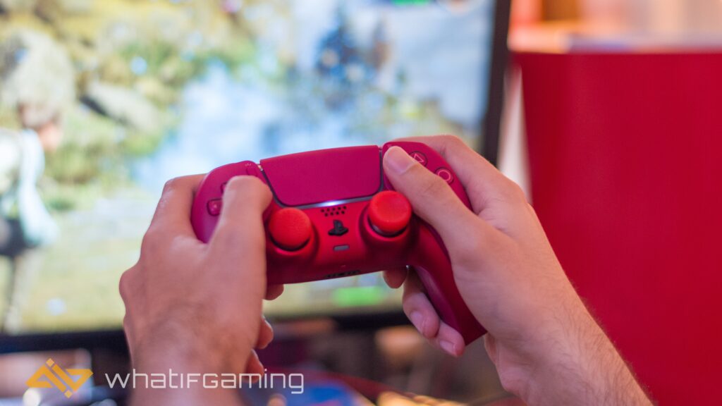 Image shows a player enjoying a videogame with a red controller