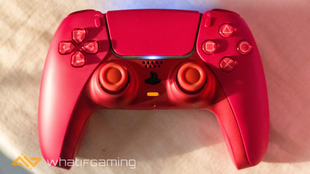 Image has a red controller on white cloth background