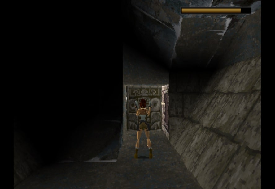 Lara Croft with her traditional pose when the guns are drawn, in the first Tomb Raider game.